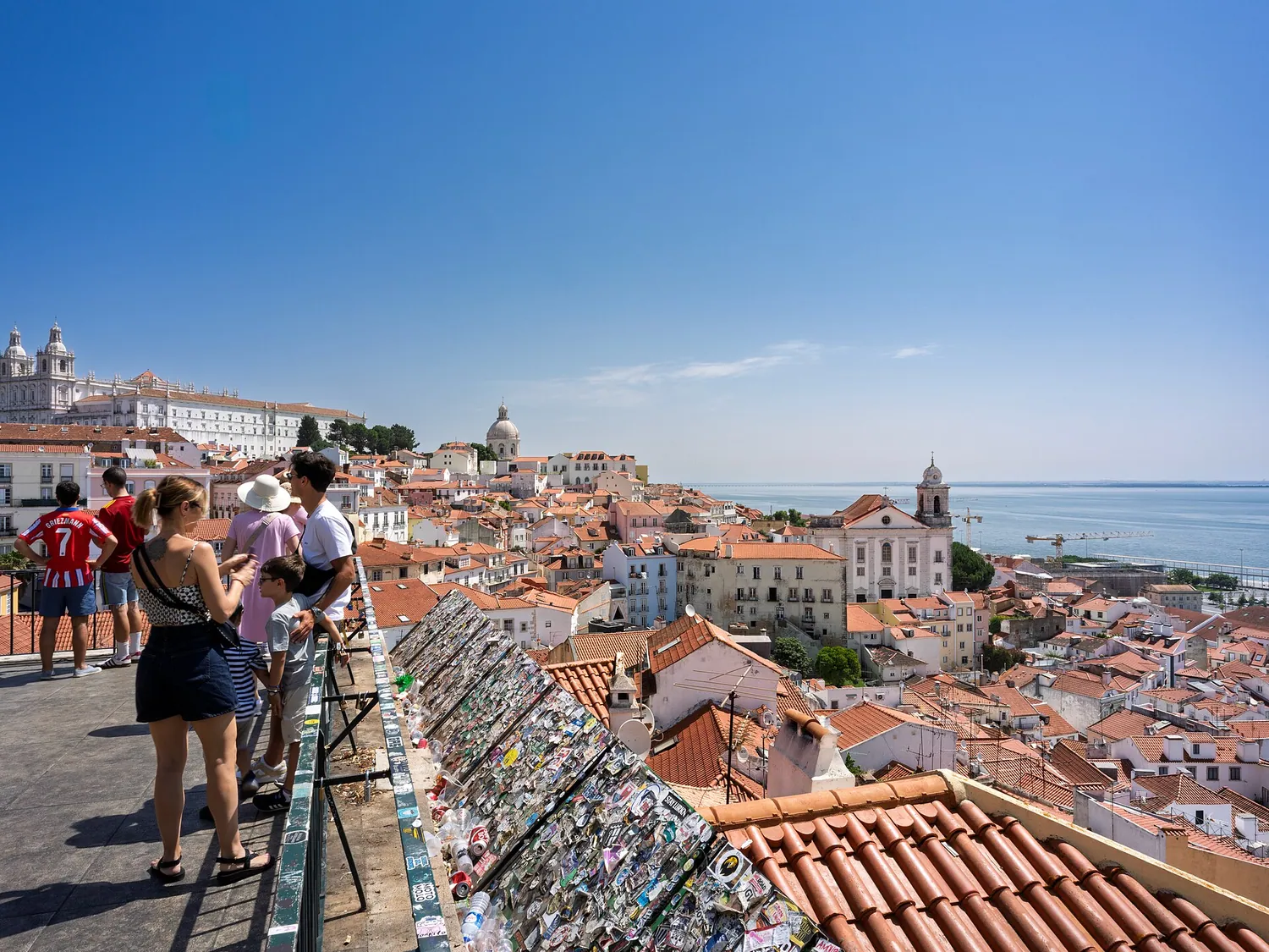 View over Alfama rooftops and the Tagus from Miradouro de Santa Luzia