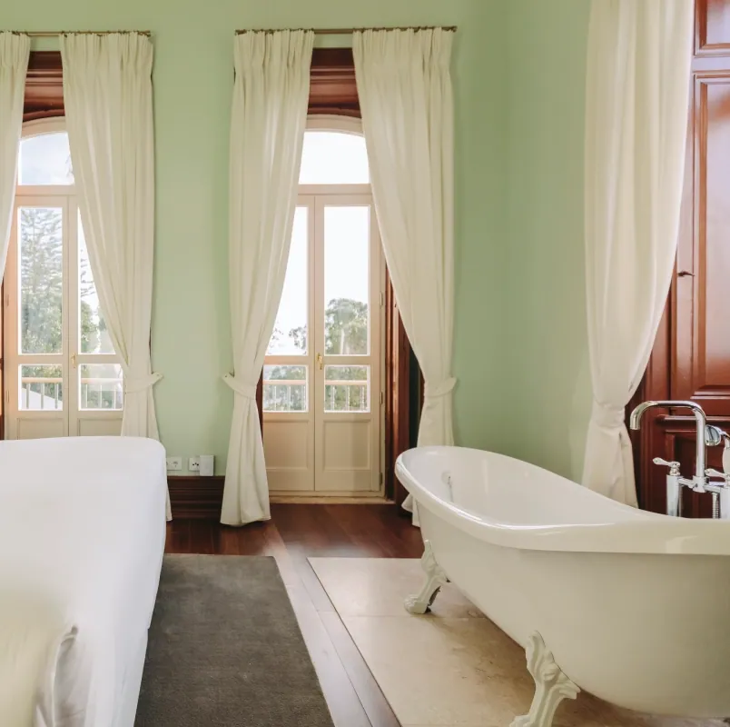 D. Duarte, pale green room with a freestanding tub