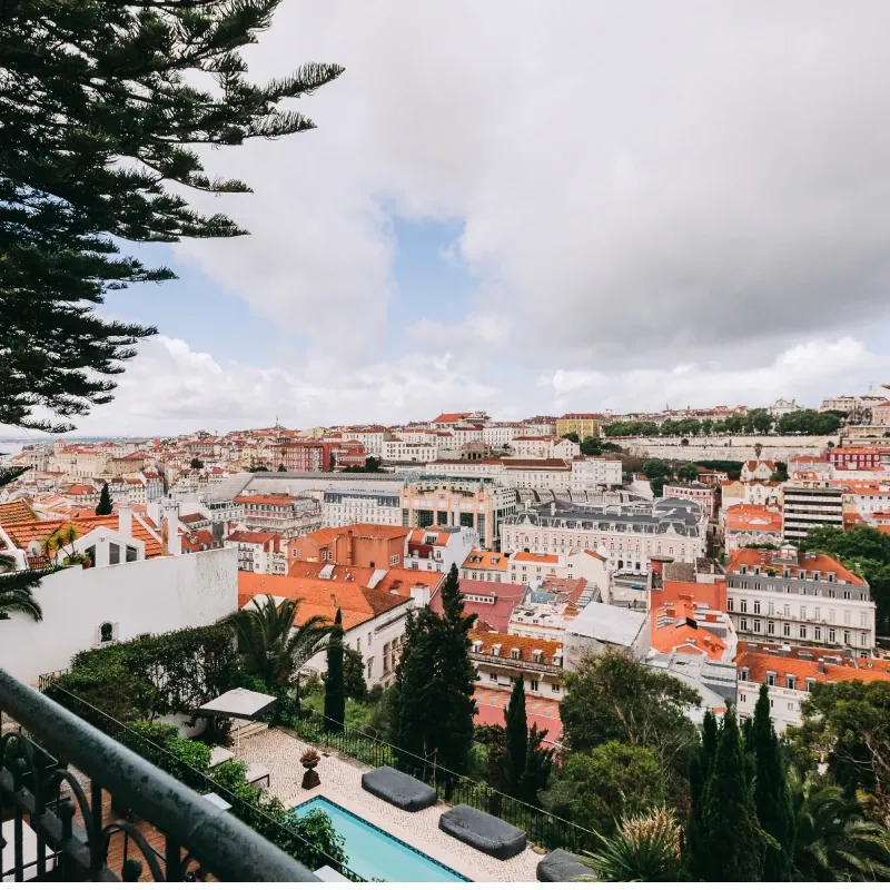 View from a Torel balcony over Lisbon rooftops with the hotel pool below